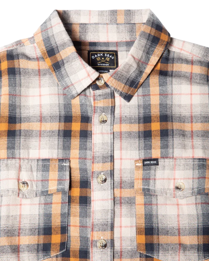 Close-up front view of Dark Seas Arrowhead grey plaid flannel shirt highlighting button placket and flap chest pockets
