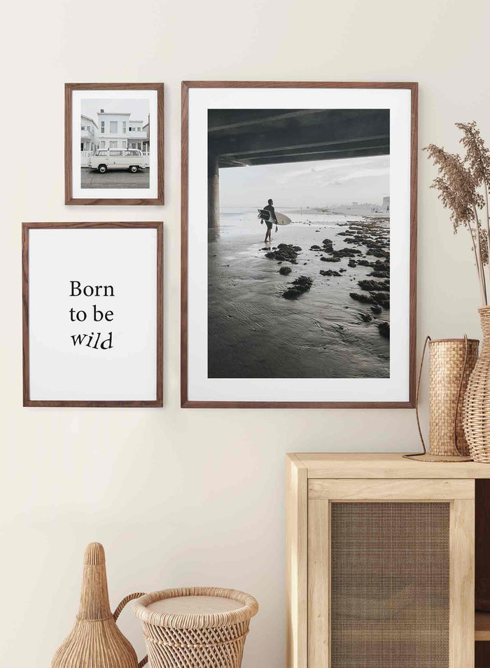 Surf Morning is a summer photography poster of a surfer carrying his surfboard under a bridge by Opposite Wall.