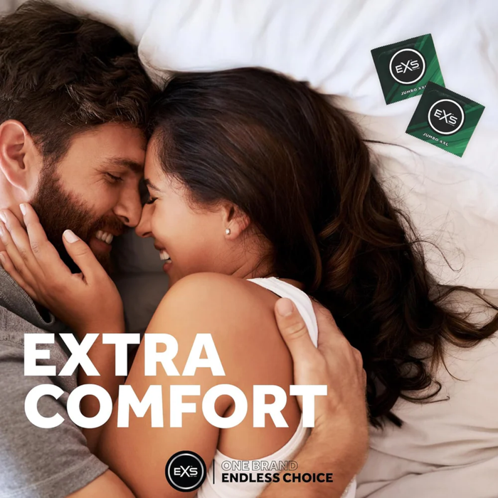 A lifestyle photograph of a smiling couple embracing closely on white bedding. Overlaid in large white text are the words "EXTRA COMFORT." In the top right corner, two green and black EXS Jumbo XXL condom wrappers are visible. The EXS logo and the tagline "One Brand Endless Choice" appear at the bottom.