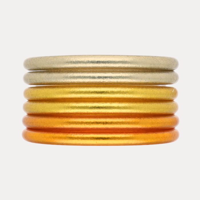 Golden Core Mixed Stack featuring gold and orange bangles stacked together for a radiant accessory.