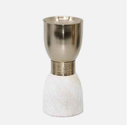 A metal candleholder with a gold upper part atop a white stone-like base.