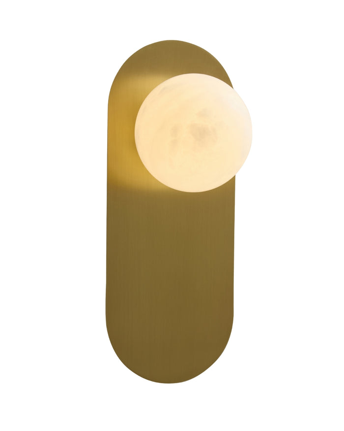 Milan wall sconce on a white background, featuring a vertical brushed brass backplate with a softly glowing opaque white glass globe mounted near the top.
