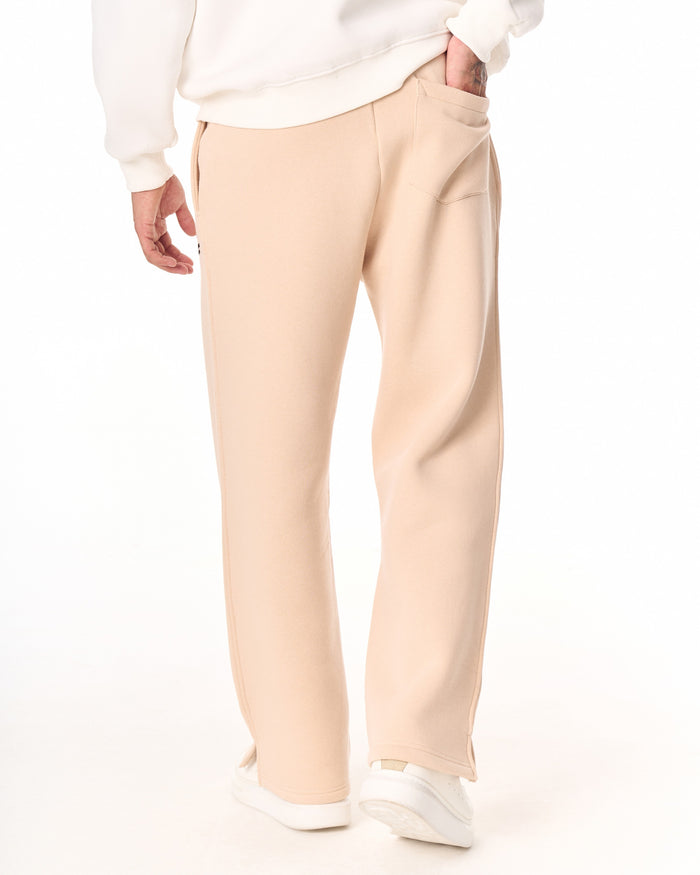 Martin Valen MV beige baggy sweatpants, rear mid-thigh view showing back pocket and sweatshirt hem