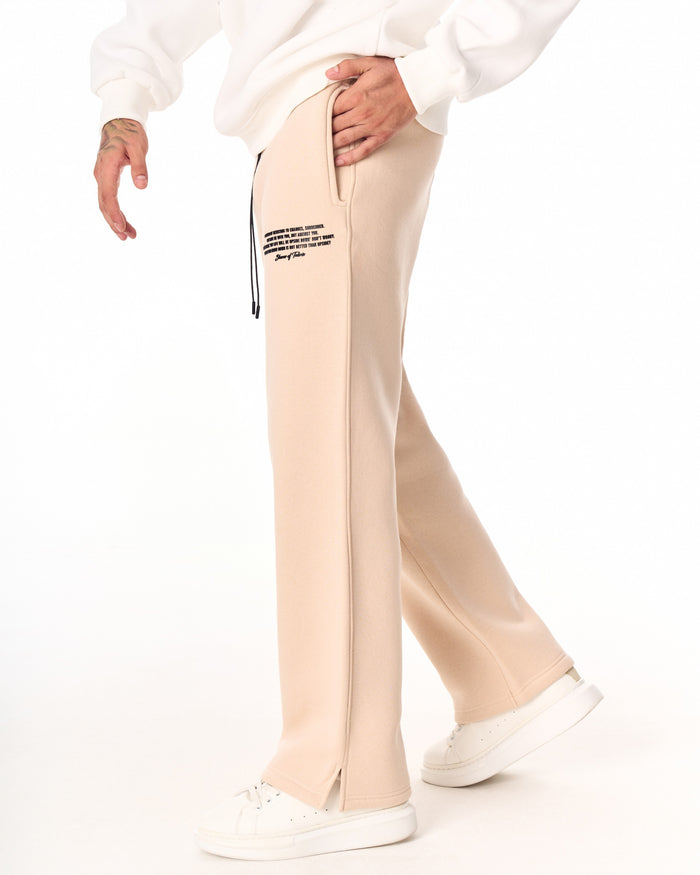 Martin Valen MV beige baggy sweatpants, front mid-thigh view with visible black drawcord and small right-side printed logo