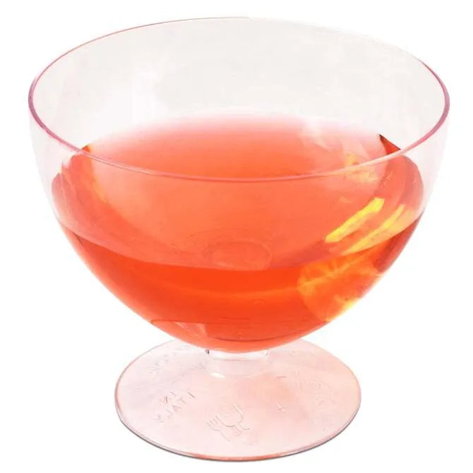 Round Goblet Glass with Base 5.92 oz. filled with orange liquid shot on white silo background.