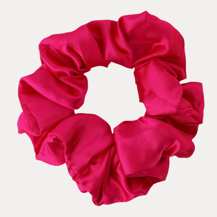 a pink scrunchie on a white background