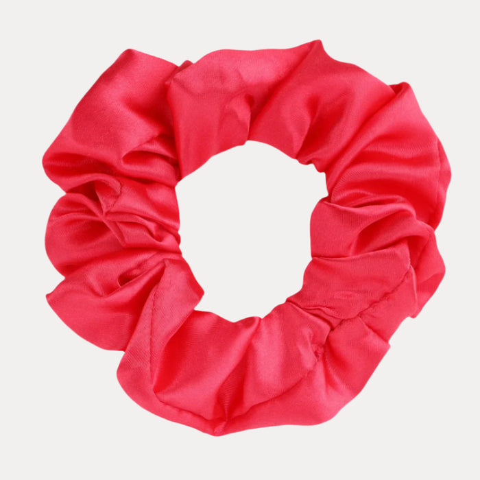 a pink scrunchie on a white background