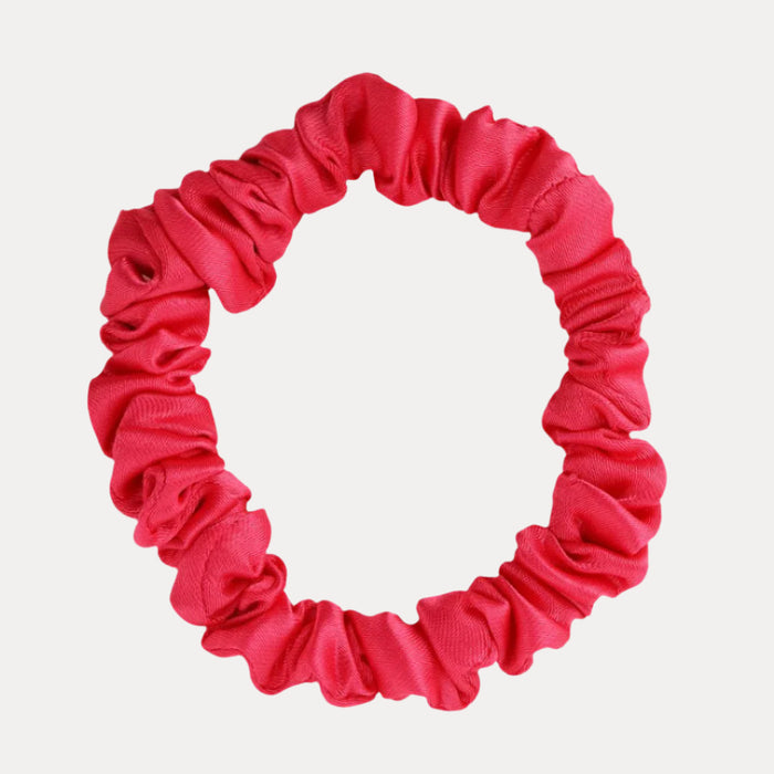 a pink scrunchie on a white background
